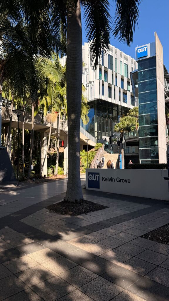 Palm trees and students on stairs at the QUT Kelvin Grove campus